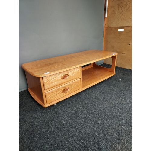 322 - An Ercol Golden Dawn elm wood coffee table. [40x124x53cm]