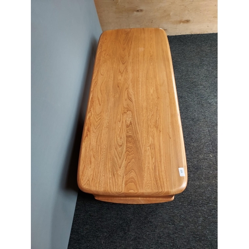 322 - An Ercol Golden Dawn elm wood coffee table. [40x124x53cm]