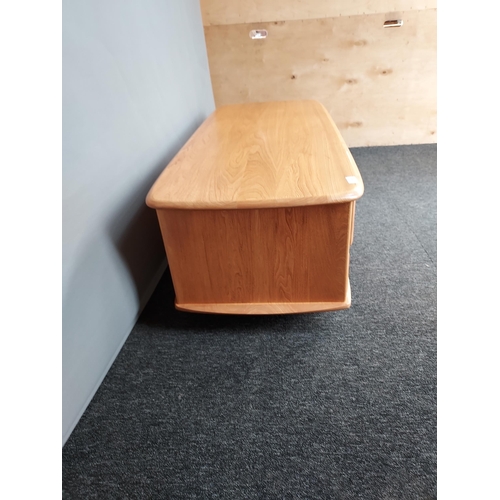 322 - An Ercol Golden Dawn elm wood coffee table. [40x124x53cm]