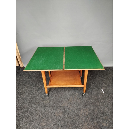 324 - A Light oak two tier games table trolley. Produced by Eastcraft Scotland [63x65x45cm]