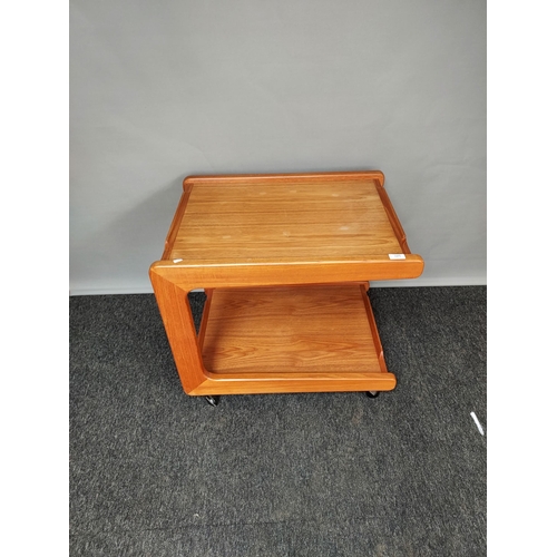 325 - A Mid century teak two tier side table, Supported on castors. [60x66x52cm]