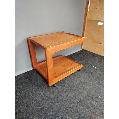 325 - A Mid century teak two tier side table, Supported on castors. [60x66x52cm]