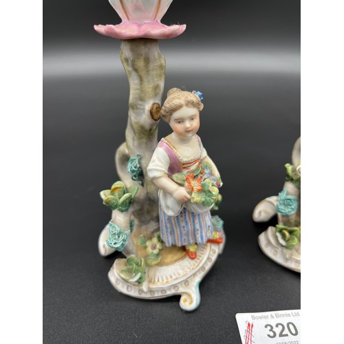 320 - A pair of 19th century Meissen figure candle stick holders. [15cm high]