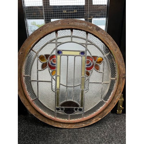 290 - A cast iron circular surround fitted with a stained glass panel. Possibly from a ship [In an art nou... 