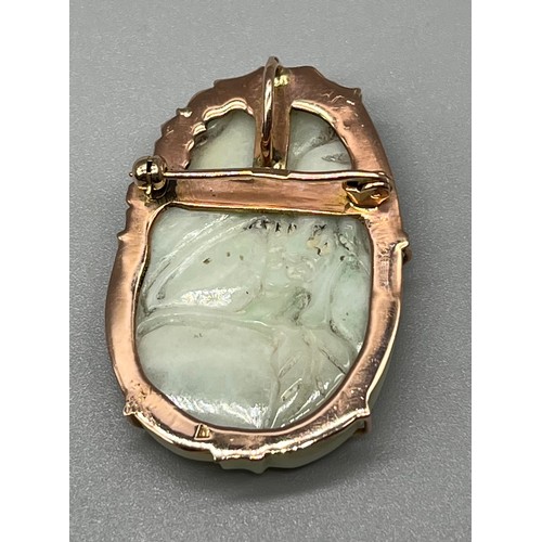 7 - A Foreign marked gold brooch/ pendant fitted with a Chinese carved Jade ingot. [4x3cm] [We will post... 