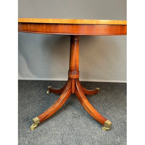 254 - Antique style mahogany table, the circular surface with banding and inlaid shell design, raised on a... 