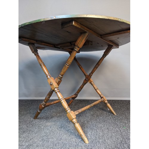 206 - Victorian folding coaching table, the top opening to an oval surface, raised on folding X-frame legs... 