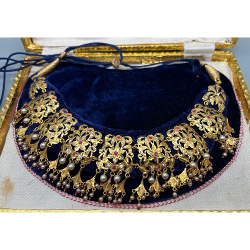 21 - Two ornate Indian 24ct yellow gold dress/ ceremonial  necklaces, decorated with pearls, ruby and whi... 