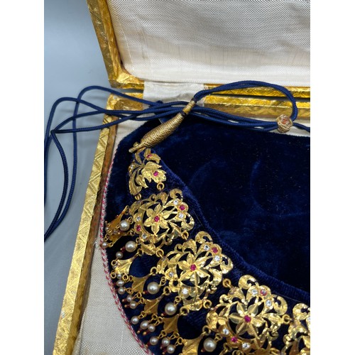 21 - Two ornate Indian 24ct yellow gold dress/ ceremonial  necklaces, decorated with pearls, ruby and whi... 