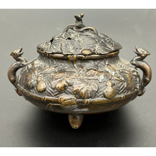 338 - A Chinese bronze incense burner supported on bun feet. [8x11x9.5cm]