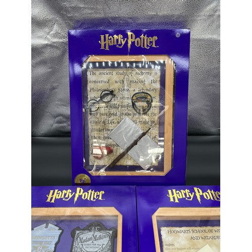 382 - Three 'The Magic Cauldron Company' Limited Edition wall hanging Harry Potter display cabinets contai... 