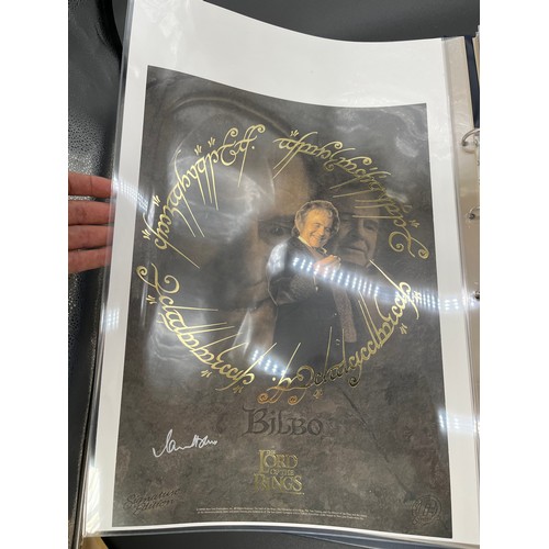 380 - An album containing various signed Lord of the rings posters and limited edition posters, some with ... 