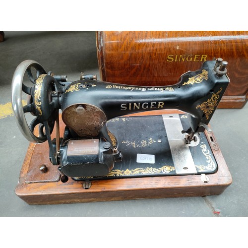 210 - Singer sewing machine in fitted case.