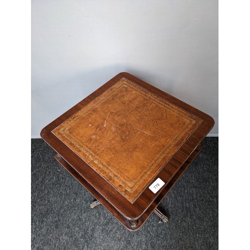 778 - Mahogany leather top table with undertier, raised on outswept legs ending in brass cap feet  (62x40c... 