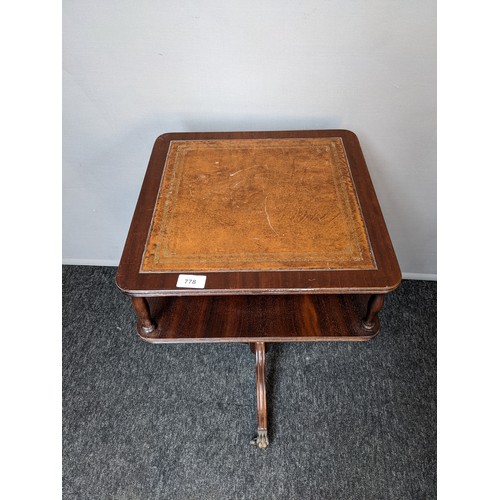 778 - Mahogany leather top table with undertier, raised on outswept legs ending in brass cap feet  (62x40c... 