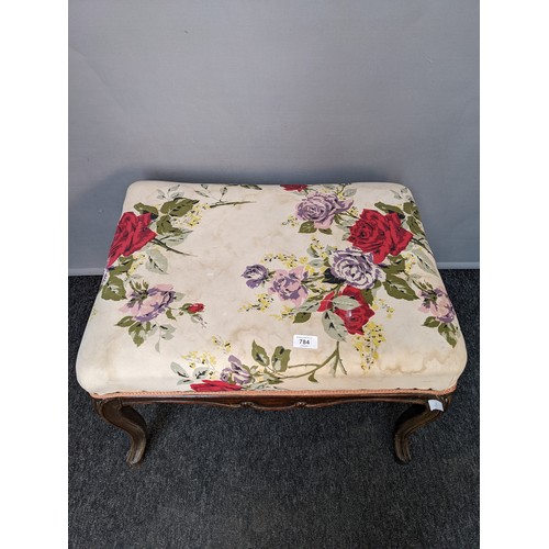 784 - 19th century stool, the rectangular floral upholstered top raised on cabriole legs (44x62x47cm)