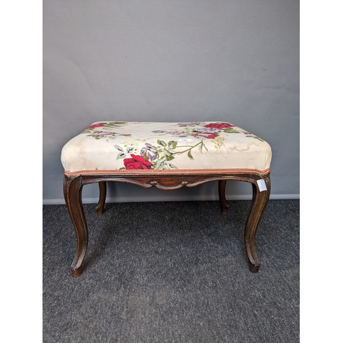 784 - 19th century stool, the rectangular floral upholstered top raised on cabriole legs (44x62x47cm)