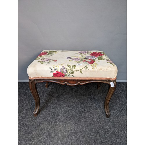 784 - 19th century stool, the rectangular floral upholstered top raised on cabriole legs (44x62x47cm)