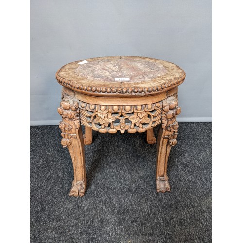 788 - 19th/20th century oriental stand, the shaped circular top with marble insert above a pierced and car... 