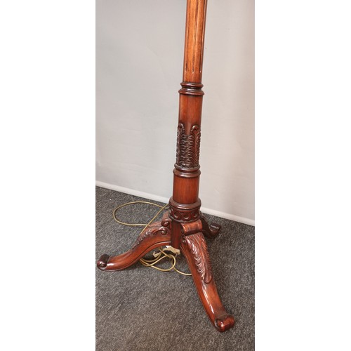 765 - Antique style mahogany floor lamp, carved detail throughout, raised on a trio of out swept legs [153... 