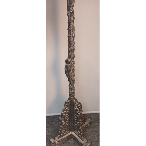 771 - Chinese highly carved floor standing lamp surmounted by a dragon head, raised on a quadiform base