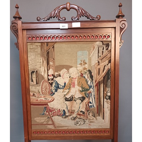 801 - 19th century fire screen, the carved handle above a rosewood frame, the centre with needlework tapes... 