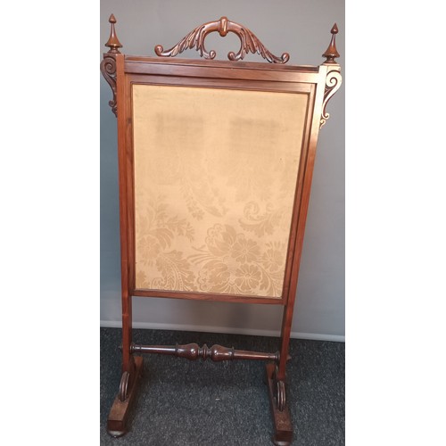 801 - 19th century fire screen, the carved handle above a rosewood frame, the centre with needlework tapes... 