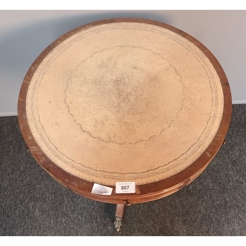 807 - 19th century circular table, the top with leather surface above band of drawers with some opening an... 