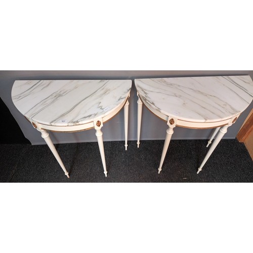 823 - Two French style demi line tables, the marble top raised on turned tapered legs (78x76x38.5cm)