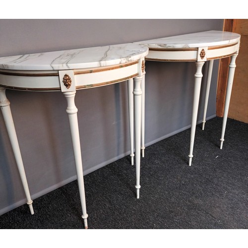 823 - Two French style demi line tables, the marble top raised on turned tapered legs (78x76x38.5cm)