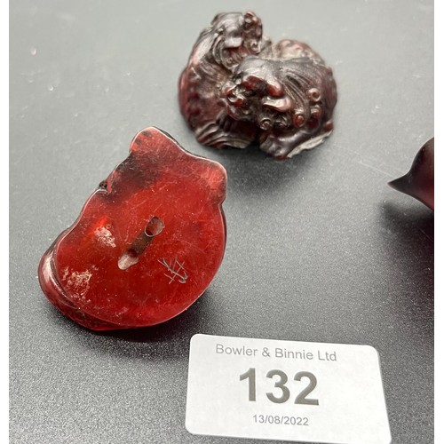 707 - Three Japanese hand carved cherry amber netsukes. All signed to the base. [Cat- 5cm in length] [0.60... 