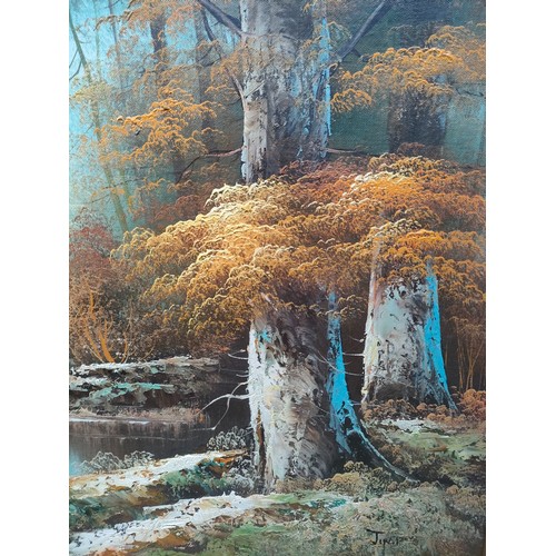 424 - Oil painting depicting river and forest scene signed Jin P fitted in a gilt frame.