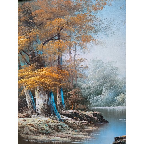 424 - Oil painting depicting river and forest scene signed Jin P fitted in a gilt frame.