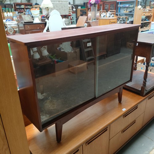 457 - Mid century book case cabinet on pedestal legs .