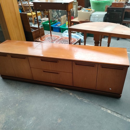 456 - A possible McIntosh of Kirkcaldy mid century teak side board with fitted drawers and cupboards .