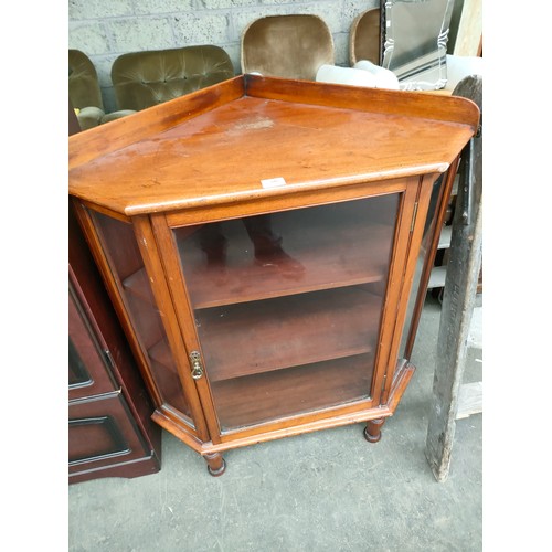 395 - Antique pedestal glass front corner cabinet.