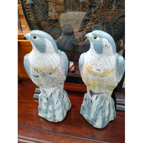 392 - Pair of falcon garden decoys.