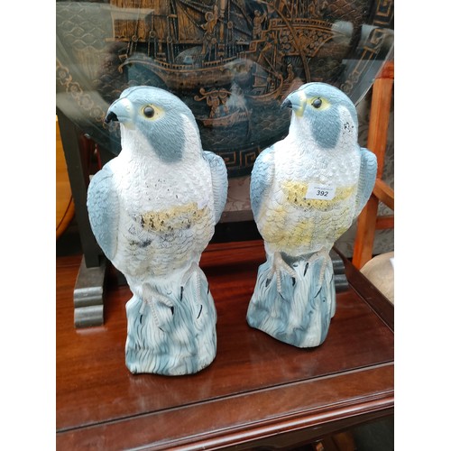 392 - Pair of falcon garden decoys.