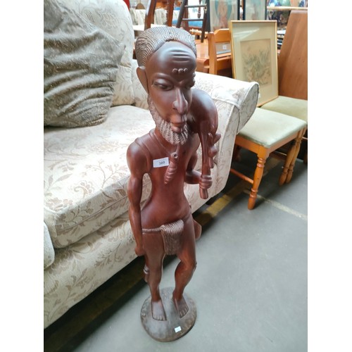 389 - Large solid wood hand carved African man warrior figure over 3ft in height .