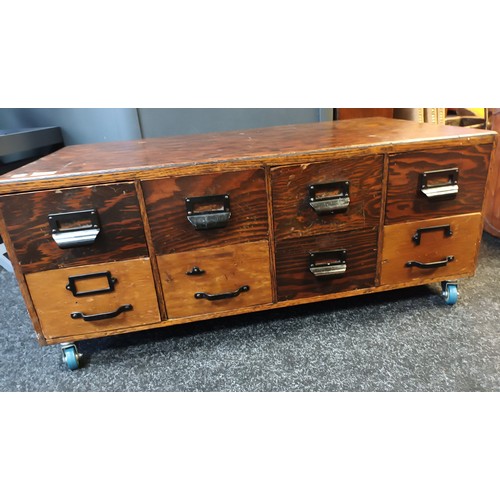 857 - Vintage oak bank of drawers [8 in total] Supported on modern wheels. Hight 40 cm x W 50 cm x L 97 cm