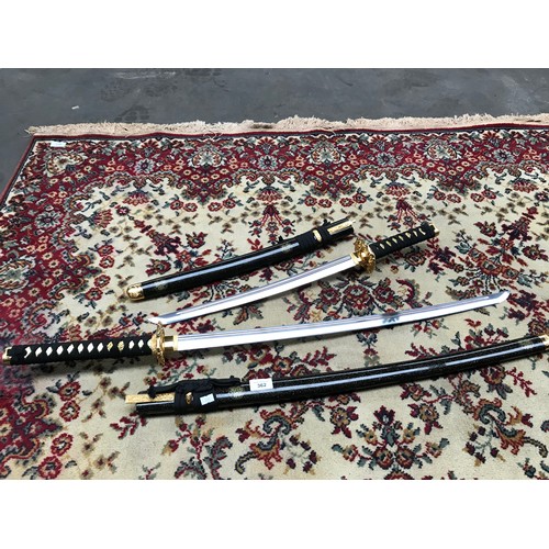 362 - Pair of decorative ornamental samurai swords .