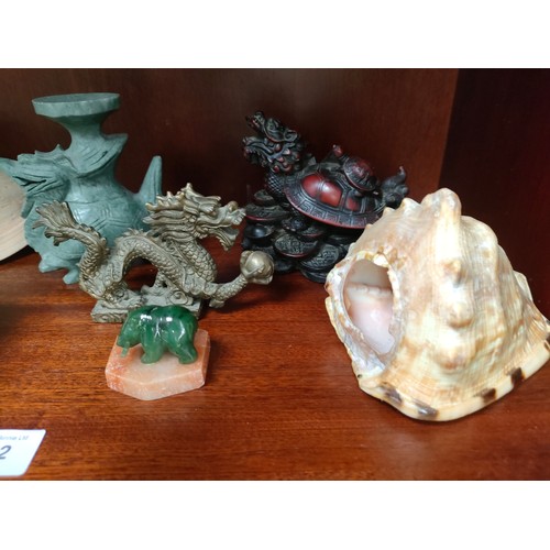 342 - Lot of oriental themed collectables includes bronzed dragon etc .