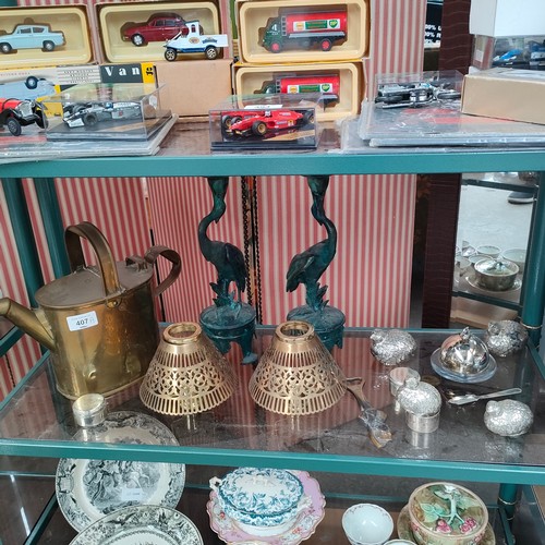 407a - Shelf of collectables includes brass watering can , metal bronze style bird candle sticks etc .