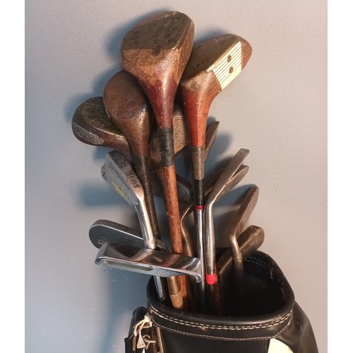 734 - Hickory shafted golf clubs within leather bound carrier, some to include various branded names from ... 