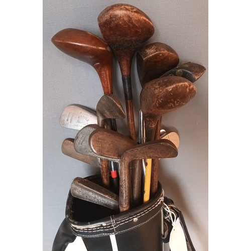 734 - Hickory shafted golf clubs within leather bound carrier, some to include various branded names from ... 