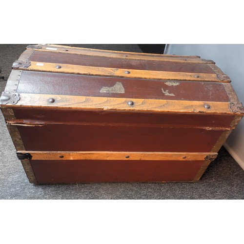 736 - Vintage domed top metal and wood bound travel trunk on castors  [45x75]