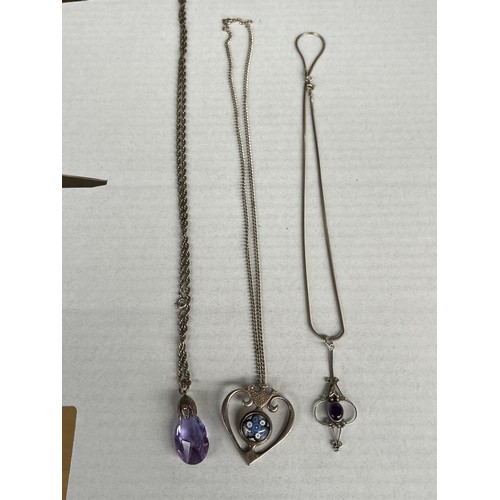 39 - Three silver necklaces with two silver pendants and one other. Includes heart shaped and glass desig... 