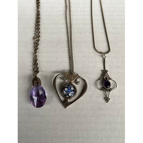 39 - Three silver necklaces with two silver pendants and one other. Includes heart shaped and glass desig... 