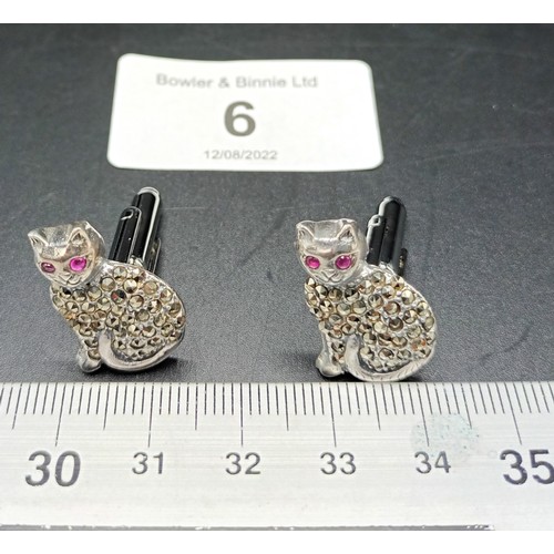 6A - A pair of silver and marcastie cat cufflinks with ruby eyes