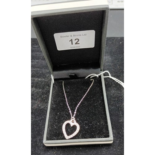 12A - A 9ct white gold diamond set heart shaped pendant necklace